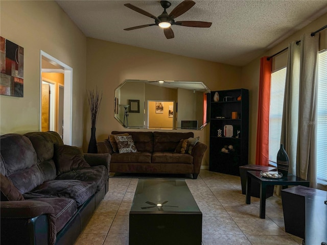 909 Royalton Rd, Orlando, FL 32825 - living room with ceiling fan, lofted ceiling, light tile patterned floors, and a textured ceiling