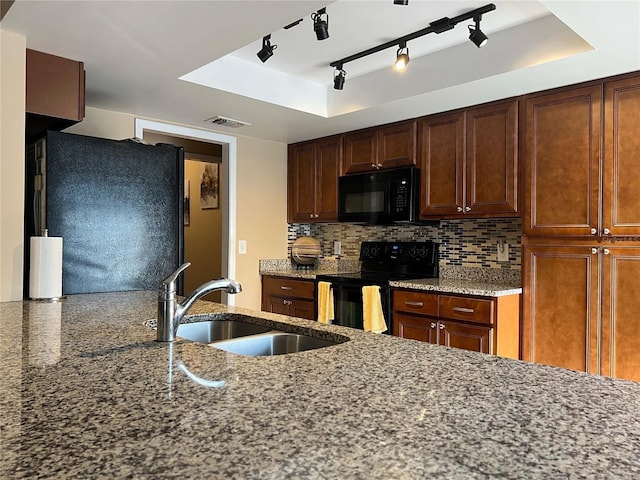 909 Royalton Rd, Orlando, FL 32825 - kitchen featuring black appliances, a sink, light stone countertops, backsplash, and rail lighting