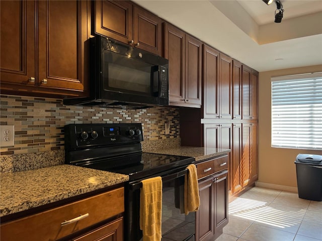 909 Royalton Rd, Orlando, FL 32825 - kitchen featuring black appliances, light stone countertops, baseboards, light tile patterned floors, and decorative backsplash