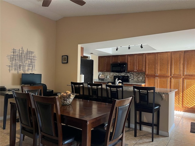 909 Royalton Rd, Orlando, FL 32825 - dining room with light tile patterned floors, ceiling fan, and vaulted ceiling