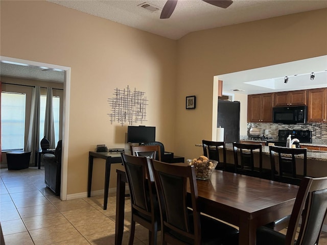 909 Royalton Rd, Orlando, FL 32825 - dining area featuring light tile patterned floors, a ceiling fan, and baseboards