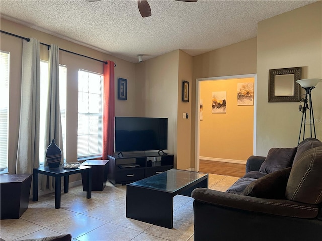 909 Royalton Rd, Orlando, FL 32825 - living area with ceiling fan, a textured ceiling, and light tile patterned floors