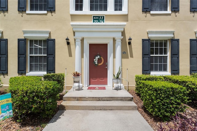 property entrance with stucco siding
