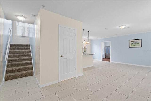interior space with tile patterned floors and baseboards