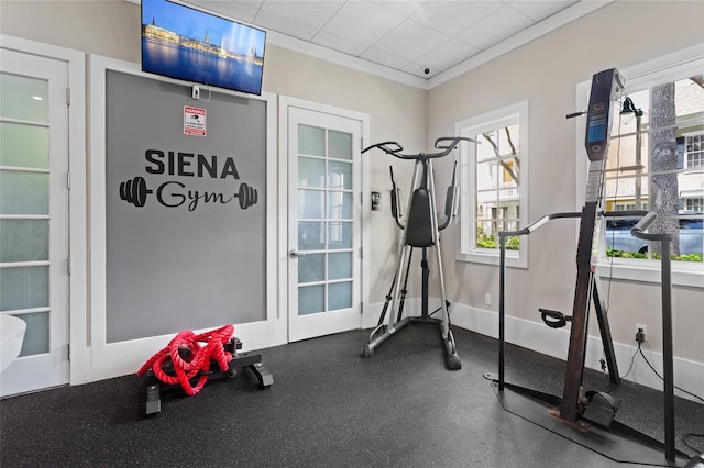 exercise room featuring baseboards and a wealth of natural light