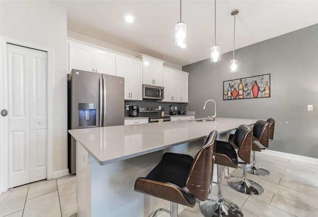 4983 Windermere Ave, Kissimmee, FL 34746 - kitchen with appliances with stainless steel finishes, a sink, tasteful backsplash, and white cabinetry