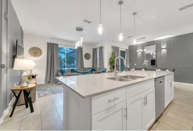 4983 Windermere Ave, Kissimmee, FL 34746 - kitchen with a sink, dishwasher, open floor plan, and baseboards