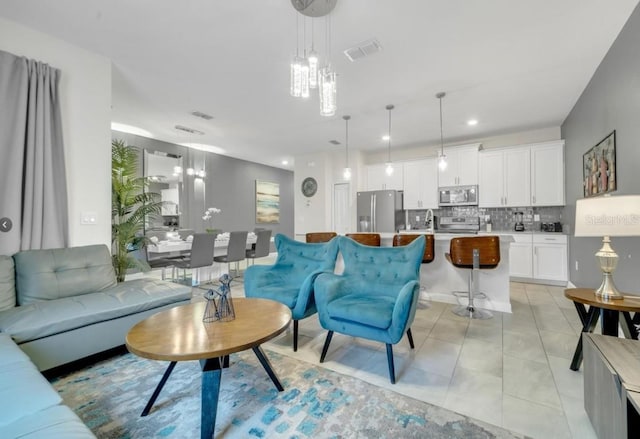 4983 Windermere Ave, Kissimmee, FL 34746 - living room with light tile patterned flooring and recessed lighting