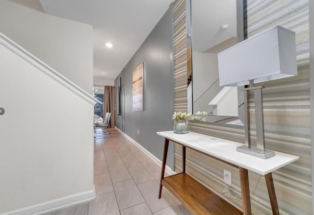 4983 Windermere Ave, Kissimmee, FL 34746 - hallway featuring baseboards, stairway, tile patterned flooring, wallpapered walls, and recessed lighting