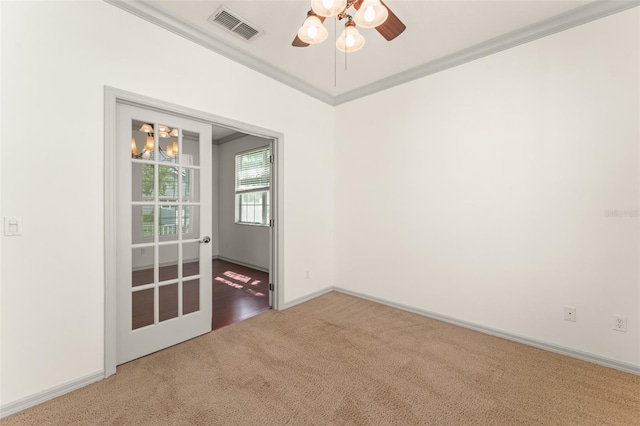 carpeted empty room featuring a ceiling fan, a chandelier, and baseboards