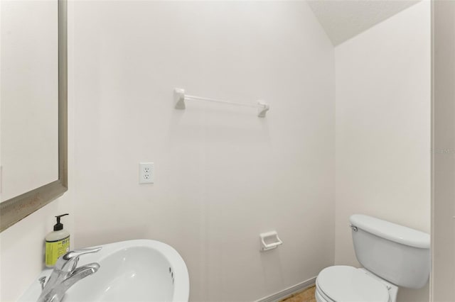 half bath featuring a sink and toilet