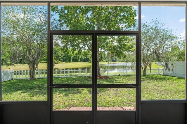 entryway with a water view and view of scattered trees
