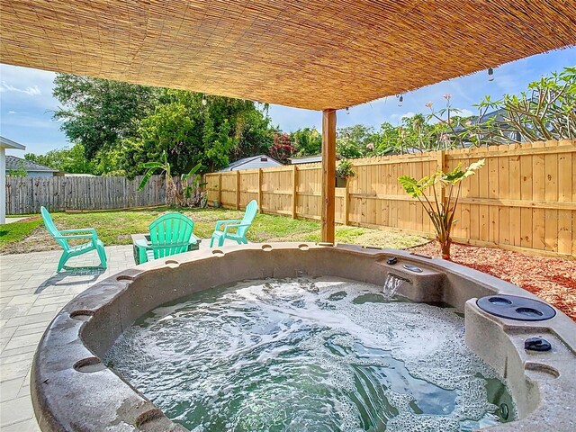 view of patio / terrace featuring a hot tub and a fenced backyard