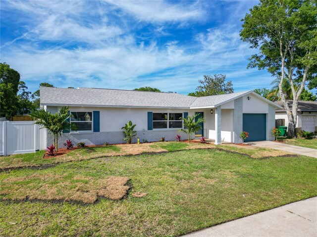 ranch-style home with brick siding, a garage, and concrete driveway