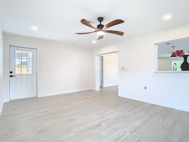 spare room featuring ceiling fan, light wood-style floors, baseboards, and recessed lighting