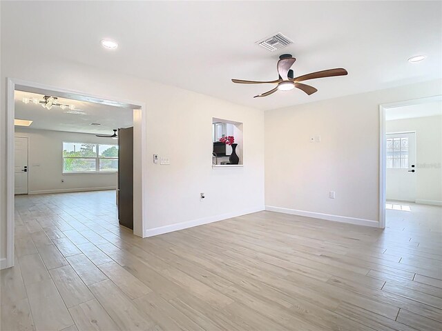 unfurnished room with ceiling fan, light wood-type flooring, baseboards, and recessed lighting