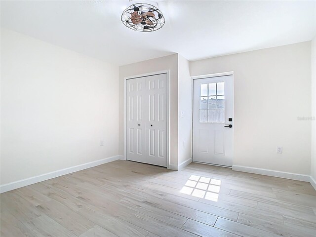 entrance foyer with light wood-style floors and baseboards