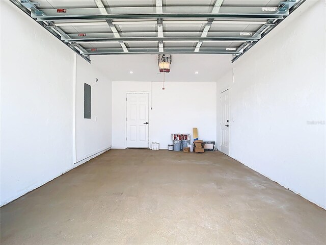 garage with electric panel and a garage door opener