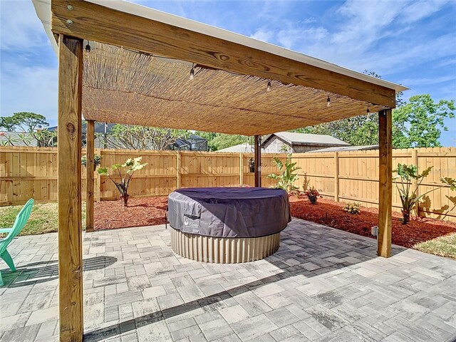 view of patio / terrace with a hot tub and a fenced backyard
