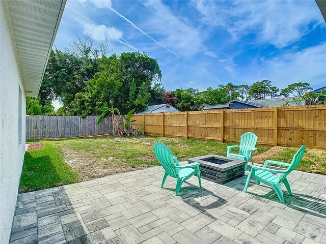 view of patio with a fire pit
