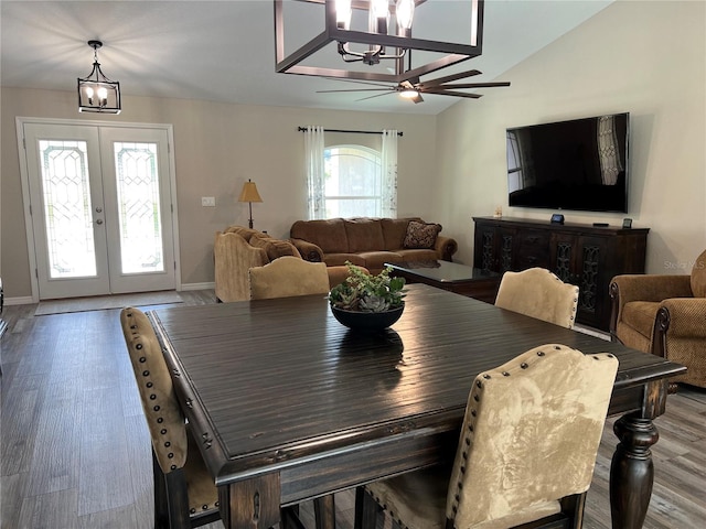 dining area with french doors, wood finished floors, baseboards, ceiling fan with notable chandelier, and lofted ceiling