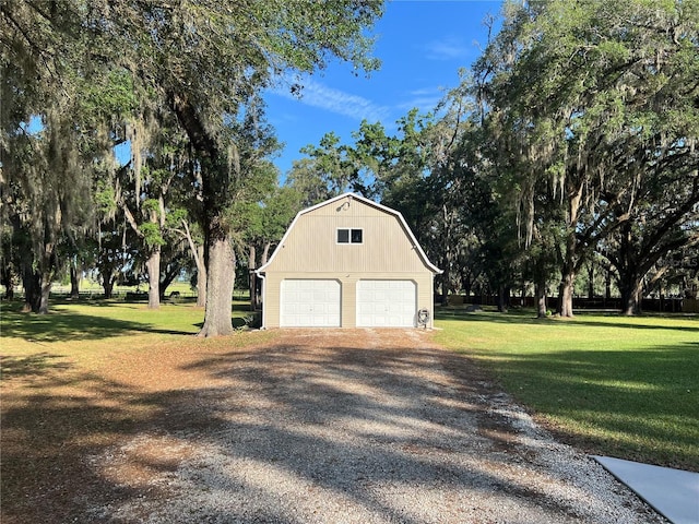 garage featuring gravel driveway and a detached garage