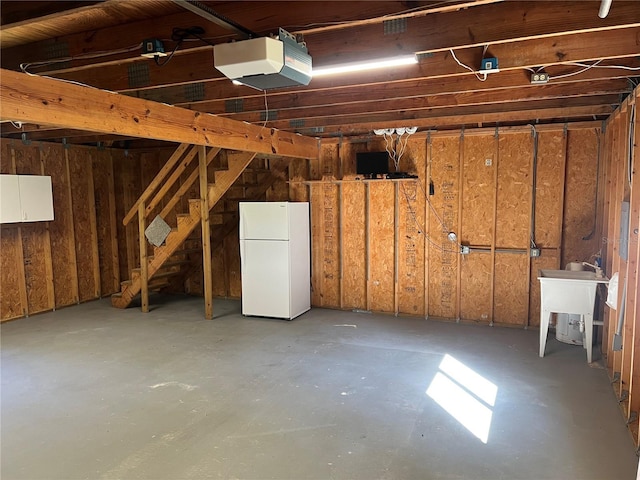 basement featuring freestanding refrigerator