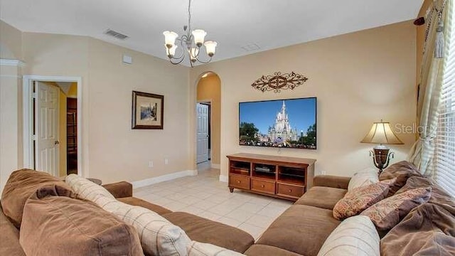 living area featuring visible vents, arched walkways, light tile patterned floors, baseboards, and a notable chandelier