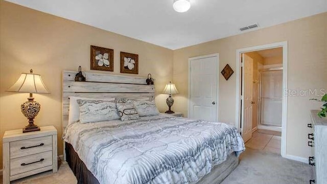 bedroom featuring visible vents, baseboards, and light carpet