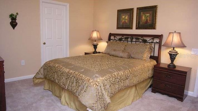 carpeted bedroom featuring baseboards