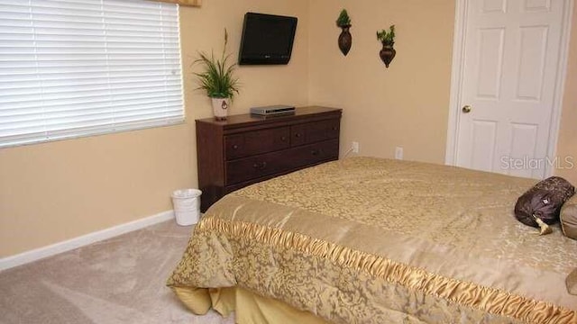 carpeted bedroom with baseboards