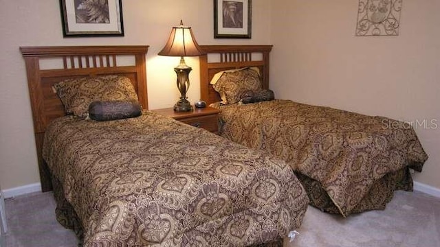 bedroom featuring carpet floors and baseboards