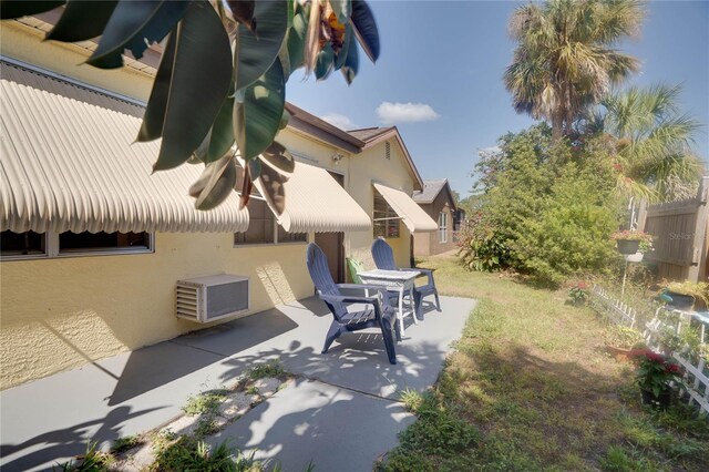 7418 Riverbank Dr, New Port Richey, FL 34655 - exterior space with stucco siding and a patio area