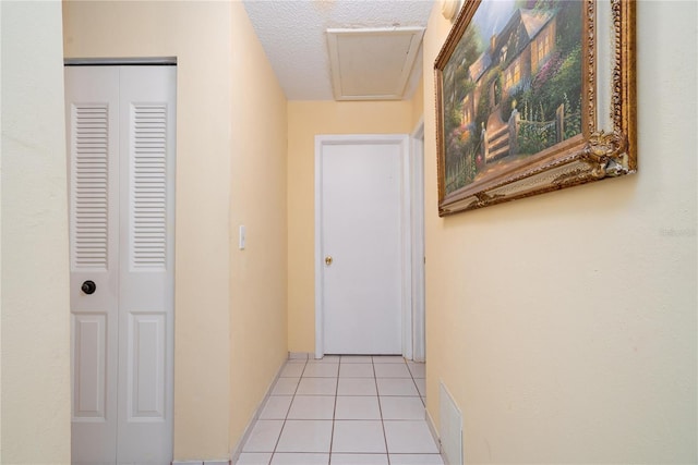7418 Riverbank Dr, New Port Richey, FL 34655 - hall with light tile patterned floors and attic access