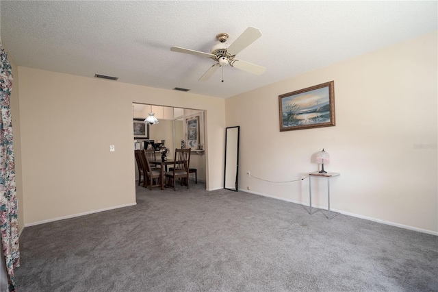 7418 Riverbank Dr, New Port Richey, FL 34655 - carpeted spare room with a ceiling fan, baseboards, and a textured ceiling