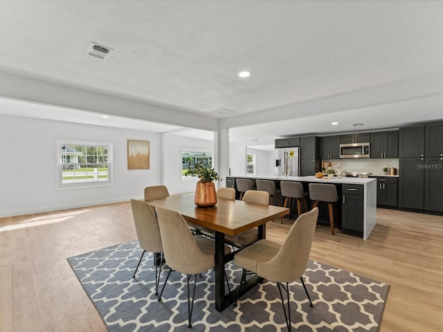 2205 Pine Island Dr, New Smyrna Beach, FL 32168 - dining space featuring light wood finished floors and recessed lighting