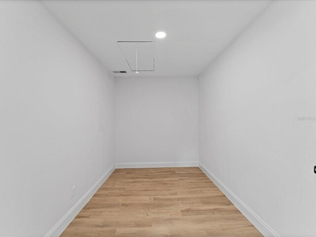 2205 Pine Island Dr, New Smyrna Beach, FL 32168 - unfurnished room with attic access, light wood-style floors, baseboards, and recessed lighting