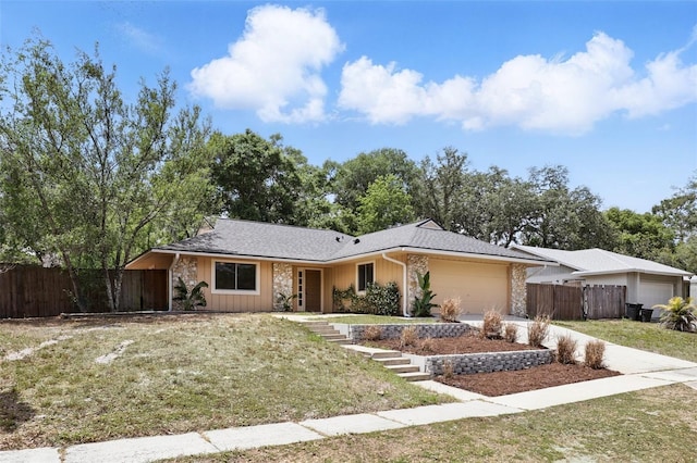 single story home featuring an attached garage, driveway, fence, and a front lawn