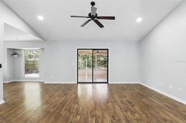 empty room featuring a ceiling fan, dark wood-type flooring, baseboards, vaulted ceiling, and recessed lighting