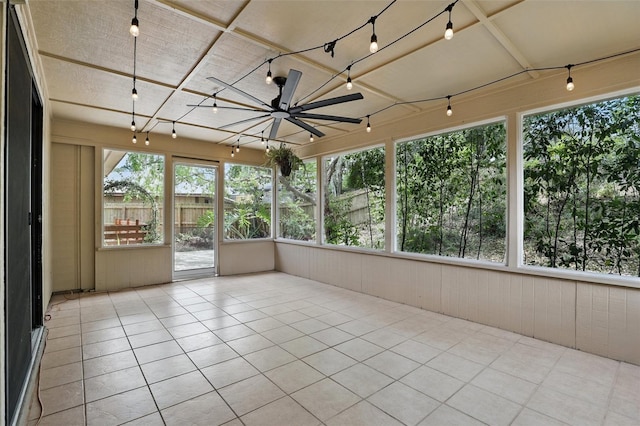 unfurnished sunroom with wooden walls and tile patterned flooring