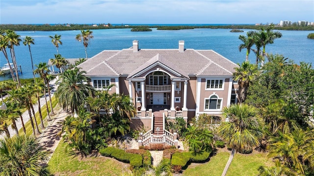 112 Osprey Point Dr, Osprey, FL 34229 - view of front of home featuring a water view, a balcony, stucco siding, and a tiled roof