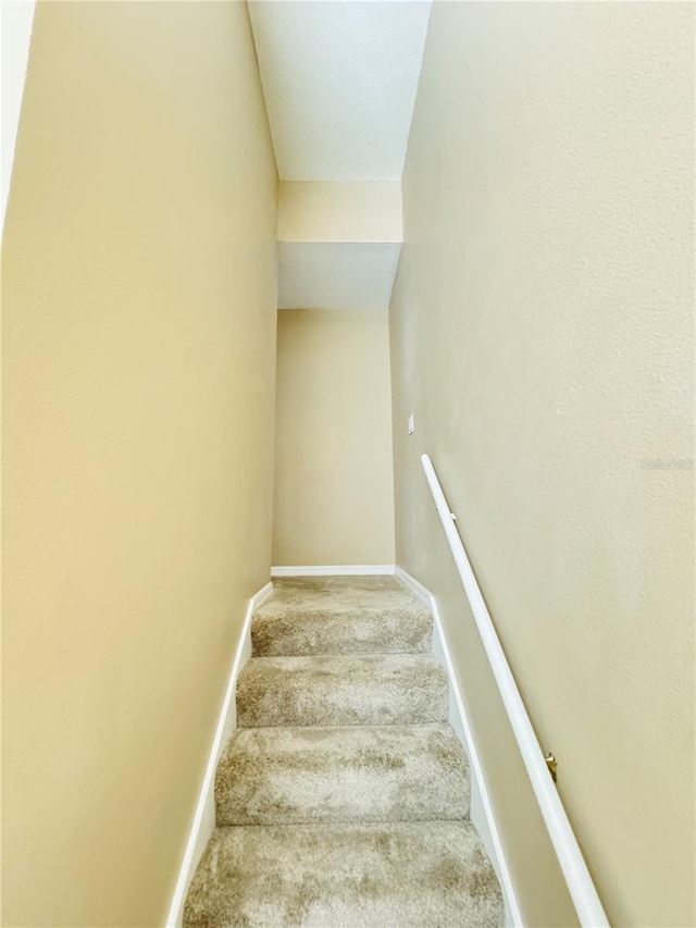 staircase with carpet and baseboards