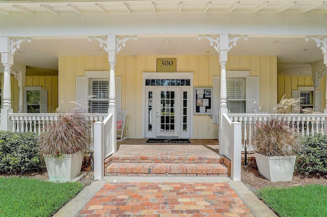 doorway to property with covered porch and board and batten siding