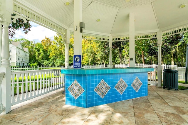 view of patio / terrace with fence, a gazebo, and central AC unit