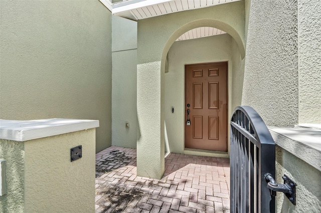 entrance to property featuring stucco siding