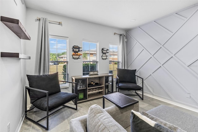 living area with baseboards and plenty of natural light