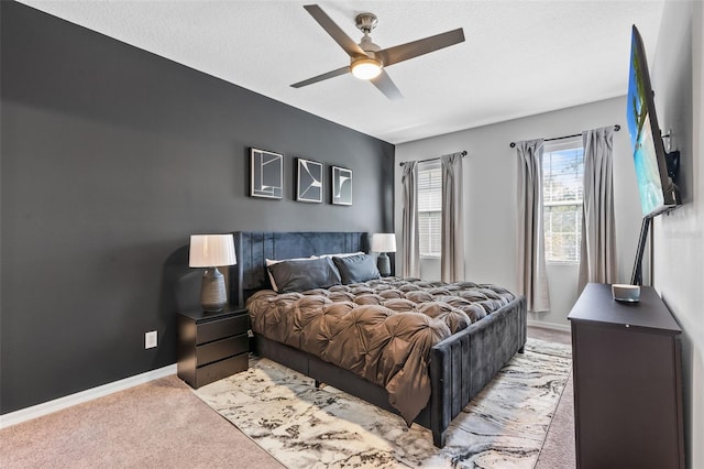 bedroom with baseboards, carpet flooring, and a ceiling fan