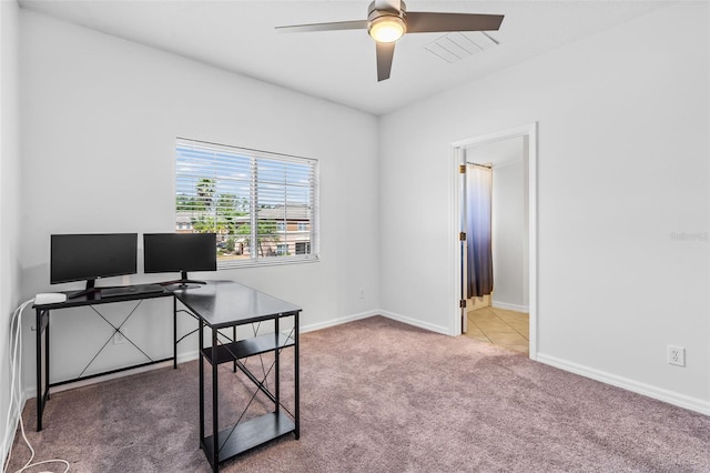 carpeted office with ceiling fan and baseboards