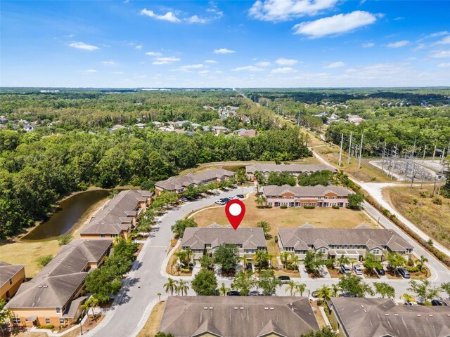 bird's eye view with a wooded view and a residential view