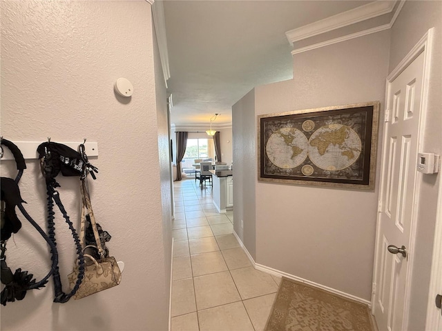 4333 Bayside Village Dr Unit 310, Tampa, FL 33615 - hall featuring crown molding, light tile patterned flooring, baseboards, and a textured wall